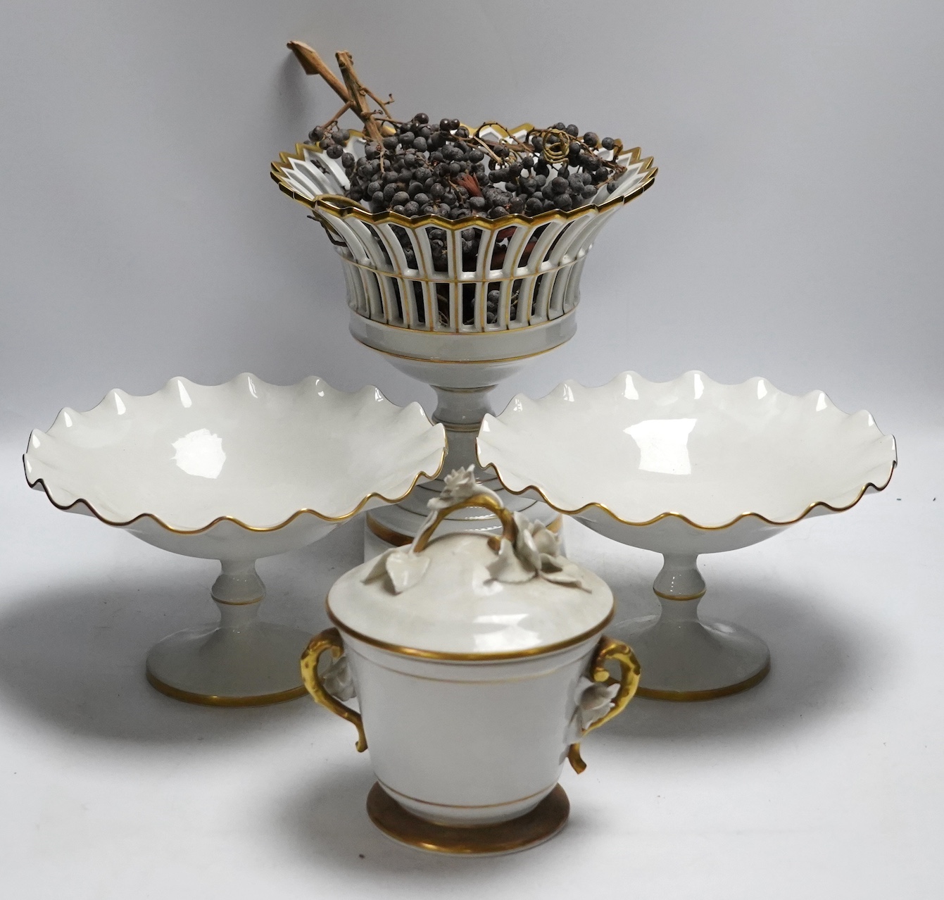 A group of Vista Allegre and other white and gilt porcelain urns, baskets etc, tallest 29.5cm